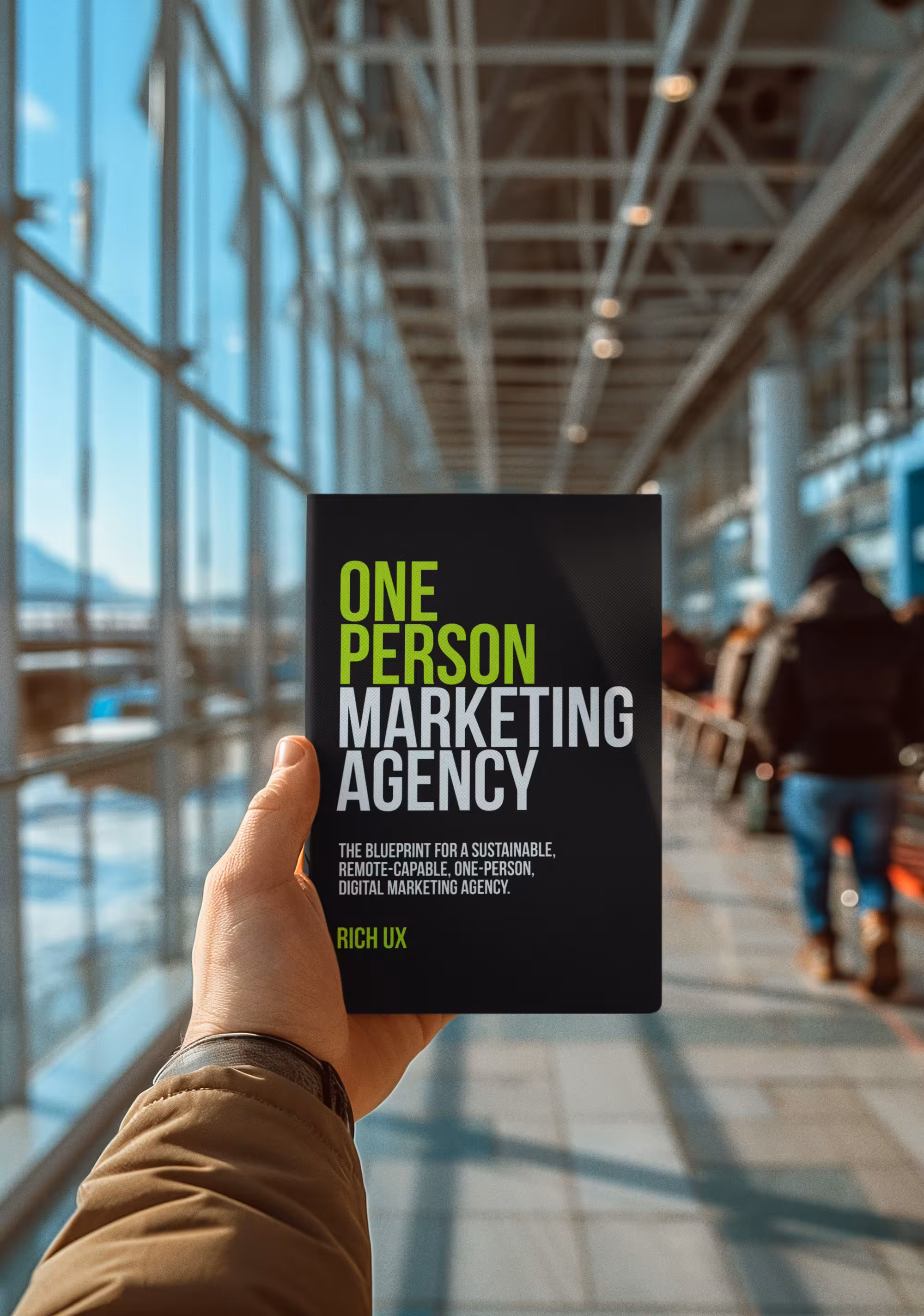 OPMA Blueprint book cover — held up at an airport